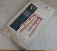 Factory sealed box showing image and branding of Life@Home wooden bar stool