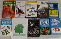 Top view of ten nature guide books covering mammals, butterflies, birds, wildflowers, trees, edible plants, reptiles