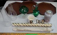 Overview showing trays, chimneys, green glass, mug, tin, patch and paper rolls