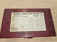 Closed red case showing printed specifications label