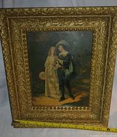 Front view ornate gold Victorian frame with romantic couple print, measuring tape for scale