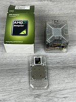 Box, CPU in clamshell, and cooler laid out on floor