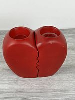 Front view of interlocked red broken-heart candle holders