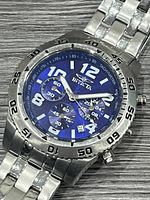 Front view showing blue dial, sub-dials, tachymeter bezel and bracelet