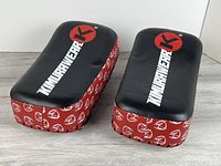Top view of both Kimurawear kick pads showing strike surfaces and branding