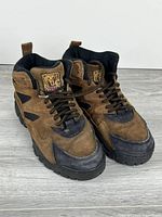 Front view of both boots showing uppers, laces, Kodak logo patches