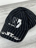Front and top view of black pinstripe cap showing NY embroidery on crown and brim