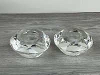 Top view of both faceted glass tealight holders on wood surface