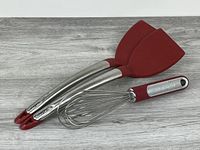 Group of kitchen utensils: two Cuisinpro spatulas and one KitchenAid whisk