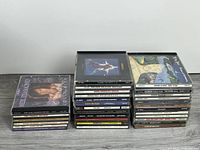 Two vertical stacks of CDs showing fronts and spines