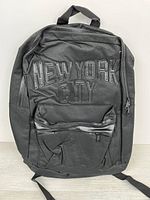 Front view showing "NEW YORK CITY" lettering and front zip pocket