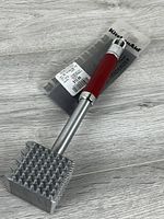 Full view of KitchenAid tenderizer in packaging