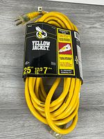 Coiled Yellow Jacket 25 ft 12/3 outdoor extension cord in retail sleeve