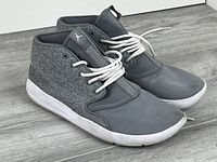 Side view of both sneakers showing uppers, laces, soles