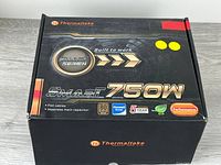 Retail box front showing Thermaltake branding and Smart 750W labeling