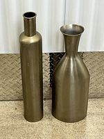 Front view of both brass-tone metal floor vases