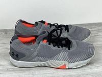 Left and right sneakers side view showing uppers, soles, colour pattern