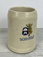Front view showing Loh-Pils logo on stein