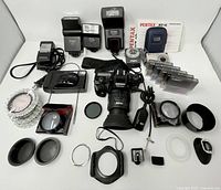 Full layout of cameras, flashes, light meter, filters, accessories