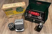 Group shot showing Coleman 421 stove open, original box, Coleman 508 case, Primus lantern topper and case