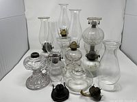 Group shot of all glass lamps, chimneys and loose burners