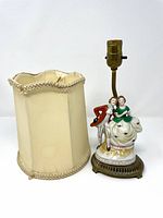 Lamp with shade beside base showing figurine and brass stem