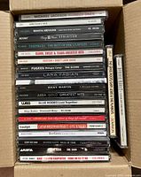 Box of CDs showing multiple visible spines