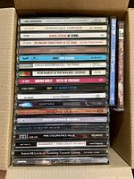 Spine view of stacked CDs showing majority of titles