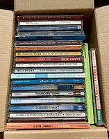 Stack of approximately 22 yoga and relaxation music CDs in box