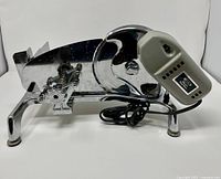 Left side view showing motor housing, frame, blade guard, power cord