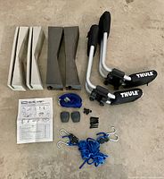 All components laid out including J-carriers, foam blocks, straps, hardware, manual