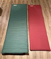 Green and red Therm-a-Rest pads side by side fully inflated