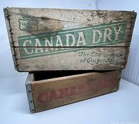 Both Canada Dry crates stacked, showing graphics and relative sizes