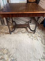 overall view of dining table showing top, turned legs, stretcher base and finish wear