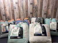 Seven sealed Mainstays bedding sets standing upright showing packaging