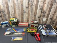 All items laid out on table including boxed tools, heat gun, cords and packaged accessories