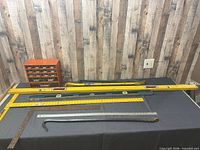 Group shot of levels, T-square, pry bars, ruler and drawer organizer