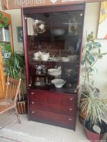 Full view of cabinet showing glass doors, finish, drawers
