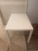 Oblique top view of white rectangular desk