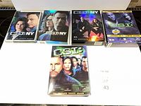 All five CSI and CSI: NY DVD box sets laid out