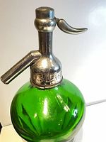 Close-up of metal head showing M. S. BEVERAGE stamp