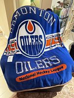 Front of blue Edmonton Oilers throw blanket showing large team logo and National Hockey League text