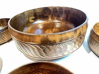 Large bowl showing carved exterior texture and wood finish