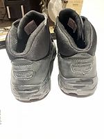 Rear view of both boots showing heel design and brand detail