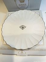 Front of scalloped plate on presentation box