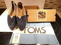 Pair of shoes with box and cloth displayed