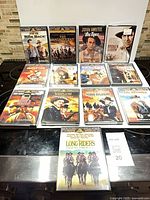 Twelve Western Legends DVDs arranged on countertop