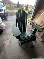 Front angled view of green Adirondack chair