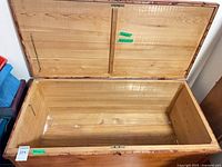 open wooden blanket chest interior view