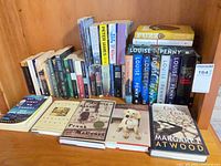 Overall shelf of fiction books, front row titles visible